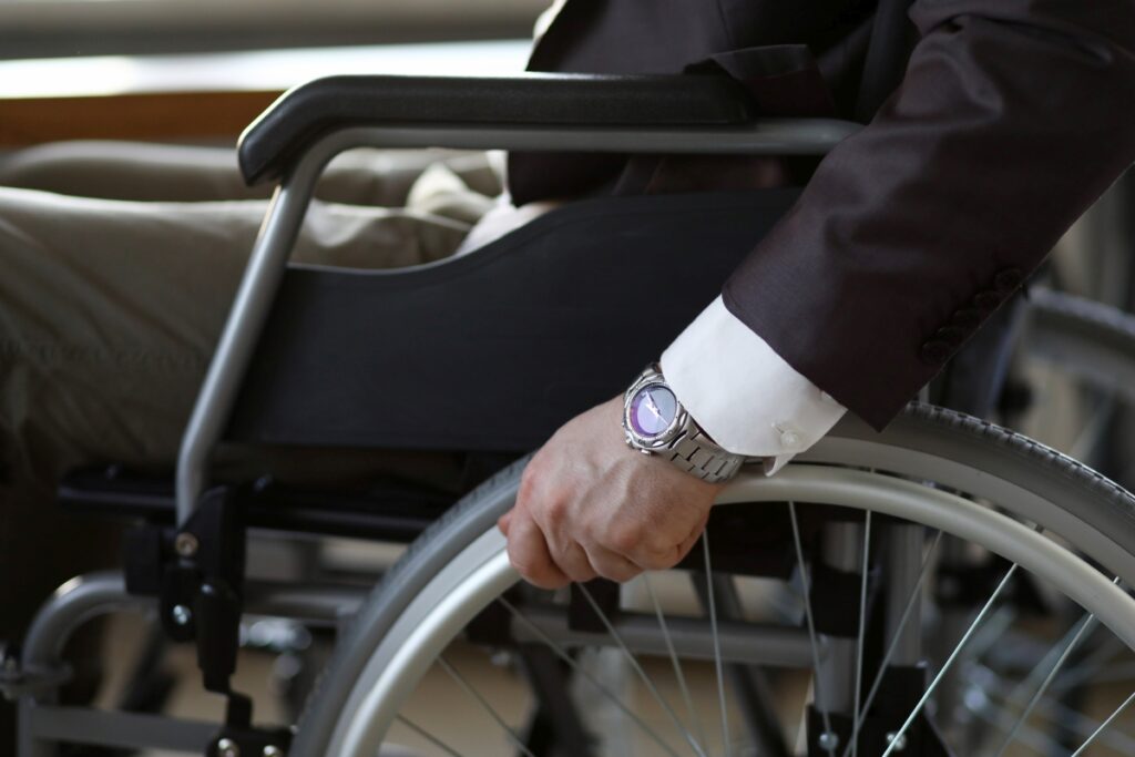 Disability businessman with wheelchair against business office